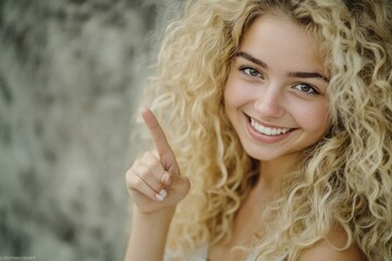 Naklejka premium A happy woman with long curly hair giving a thumbs up, great for use in advertising and marketing materials