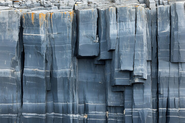 Close-up of columnar basalt rock formation, showing texture and geological patterns.