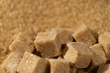 Brown cane unrefined demerara sugar in the form of crystals and cubes
