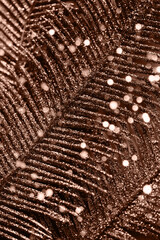 Abstract composition made of a  decorative branch closeup. Shiny festive and holiday background. Celebration and party concept. Color of the year 2025 inspired