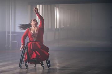 Beautiful dance in a wheelchair of a woman with disability at a dancing studio. Para dance sport. © 24K-Production