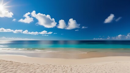 Obraz premium Panoramic photograph of a serene beach with soft beige sand, turquoise ocean waves, and a clear blue sky dotted with white clouds under the radiant sun.