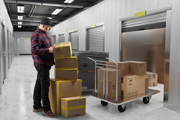 Man near self storage unit. Warehouse space rental. Guy in corridor with gate in self storage unit....