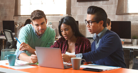Three Designers In Creative Business Using Laptop Meeting In Modern Multi-Cultural Office 