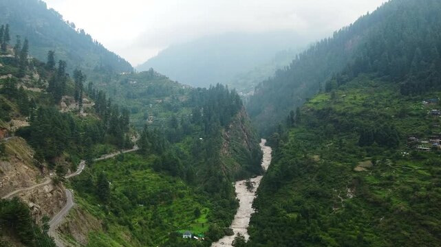 Aerial view of manikaran town with the parvati river and local houses in the parvati valley at himachal pradesh state of India.