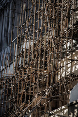 Weathered Building Wrapped in Bamboo Scaffolding