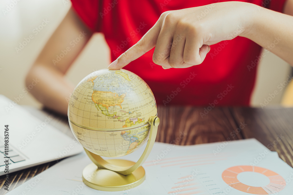 Poster exploring globe while analyzing data on desk, showcasing global awareness and research. hand points 