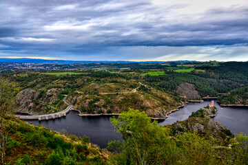 Saint-Victor-sur-Loire, France - October 5th 2024 : View of the River la Loire from a mountain close to Saint-Victor. You can see Grangent Castle, Grangent dam and the city of Andrézieux-Bouthéon.