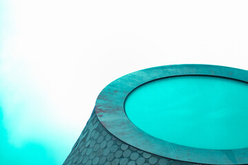 Abstract Modern Art Featuring a Vibrant Cylindrical Structure with Circular Patterns and Bold Turquoise Colors Against a Minimalist White Background for Contemporary Design Inspiration