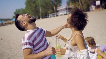 A group of young friends enjoying a sunny day at the beach, creating joyful memories together.