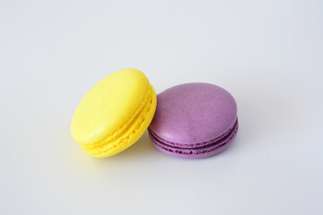 two purple and yellow macarons next to each other close up 