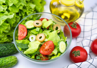 Healthy salad of fresh vegetables and greens on the table. Healthy food concept. Close-up. Selective focus.