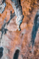 Close-Up View of a Weathered Rock Formation in Warm Tones Showing Natural Erosion Patterns and Textures