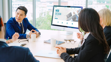 Business people in the conference room with green screen chroma key TV or computer on the office table. Diverse group of businessman and businesswoman in meeting on video conference call .