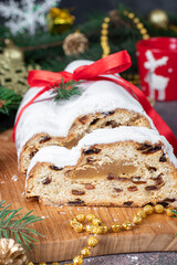 Christmas German Stollen with marzipan and dried fruits in powdered sugar. Traditional treats in...