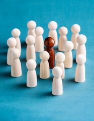 Obraz premium a paper cut of of a crowd of diverse people; wooden figures around the leader 