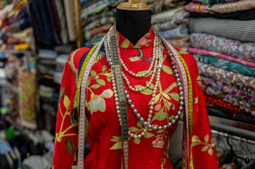Fototapeta premium A woman silk dress inside a tailor shop in Ho Chi Minh City in Vietnam