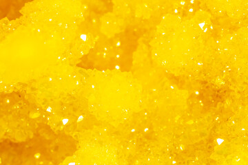 Golden crystal mineral stone. Gems. Mineral crystals in the natural environment. Texture of precious and semiprecious stones. Seamless background with copy space.