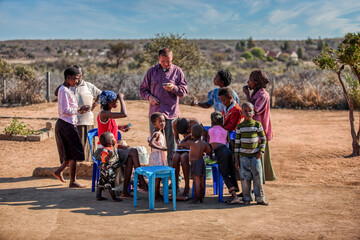 NGO charity project volunteers aim with new technologies to eradicate hunger and poverty, african village group of people in training, village in Botswana