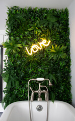 Bathroom wall decorated with LED lights and leaves