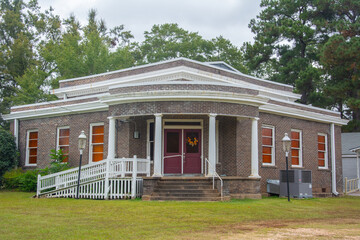 Colonial Revival building of the Emmet Methodist Church with curved portico supported by four...