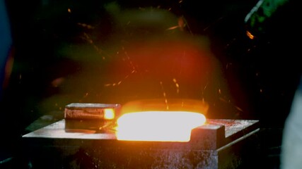 Metal hanmer press forging. metal piece shaping. automatic drop hammer giving it a tool shape. Open die forging. metal hit by a hammer on a mould cast machine tool component part. forging factory	