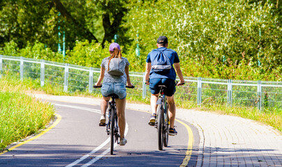 Cyclists ride on the bike path in the city Park
