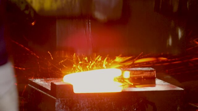 forging hammer, metal forging metal piece shaping automatic drop hammer a tool shape. Open die forging hit by hammer on a tool mould cast to form a machine component part isothermal weld factory	
