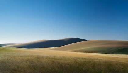 Fototapeta premium Serene landscape with rolling hills and clear sky.