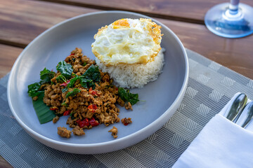 Minced chicken and fried egg with basil, famous Thai dish.