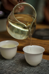 Experience the Elegant Art of Tea Pouring in a Traditional Ceremony Setting and Atmosphere