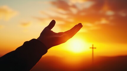Man reaching for divine assistance against a sunset backdrop with a cross