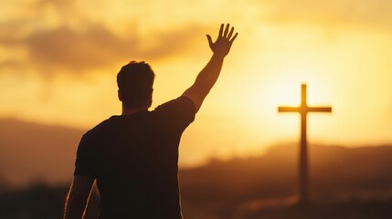 Man reaches for divine connection during a sunset near a cross on the horizon