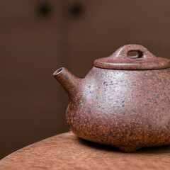 A beautiful and elegant Brown Ceramic Teapot beautifully displayed on a Wooden Table
