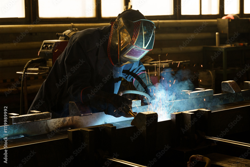Poster craftsmanship shines through welding sparks in a vibrant workshop