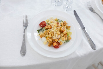 white plate with diet salad and utensils