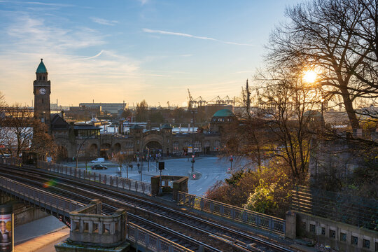 HAMBURG, GERMANY - Nov 30th, 2024: St. Pauli Landungsbruecken and Hamburg harbor in the sunset