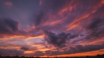 Stunning Sunset Sky with Rich Orange, Pink, and Purple Hues and Wispy Clouds
