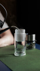 Pouring hot water into a glass container is essential for brewing the perfect beverage