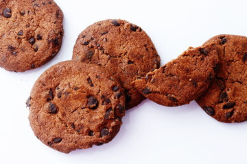 chocolate chip cookies broken on a light background