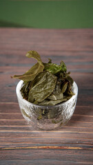 Dried Green Tea Leaves Presented Elegantly in a Stunning Bowl for Aesthetic Appeal