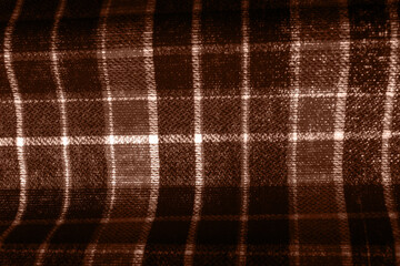Mocha Mousse background Color of 2025 year. Classic checkered lilac textile pattern. Scottish cell.