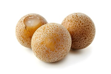Close-up of three round yellow fruits with a rough texture