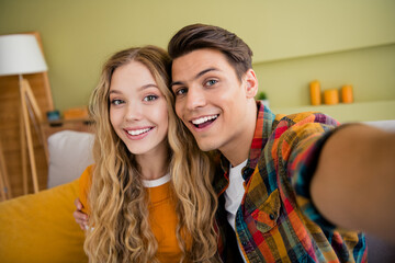 Photo of lovely young couple smile take selfie photo spend time spacious house spring summer indoors room