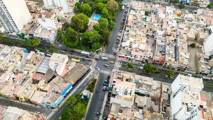 Fototapeta premium Crossing of streets with light traffic in a district in the city of lima