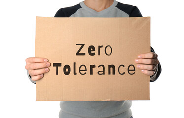 Woman holding piece of cardboard with words Zero Tolerance on white background, closeup