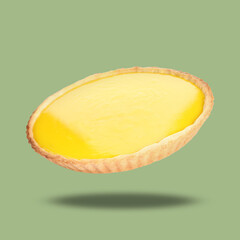 Delicious lemon pie in air on light green background