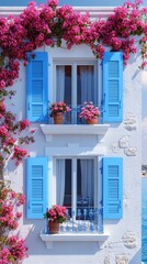 Blooming bougainvillea adorning traditional whitewashed house with blue shutters in greece