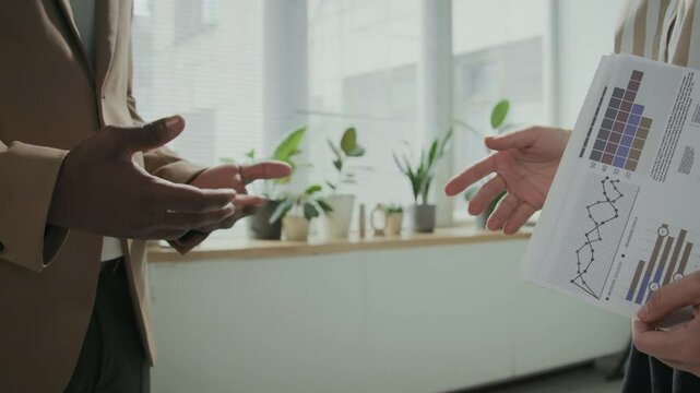 Cropped slowmo shot of two unrecognizable business partners gesticulating with their hands during startup project discussion then shaking hands after making successful deal