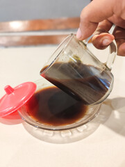 pouring tea into glass